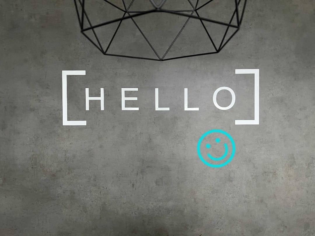 Hello m smiley 3 edited | expoline messedesign Dunkle wand mit hello und smiley zeichen in türkis